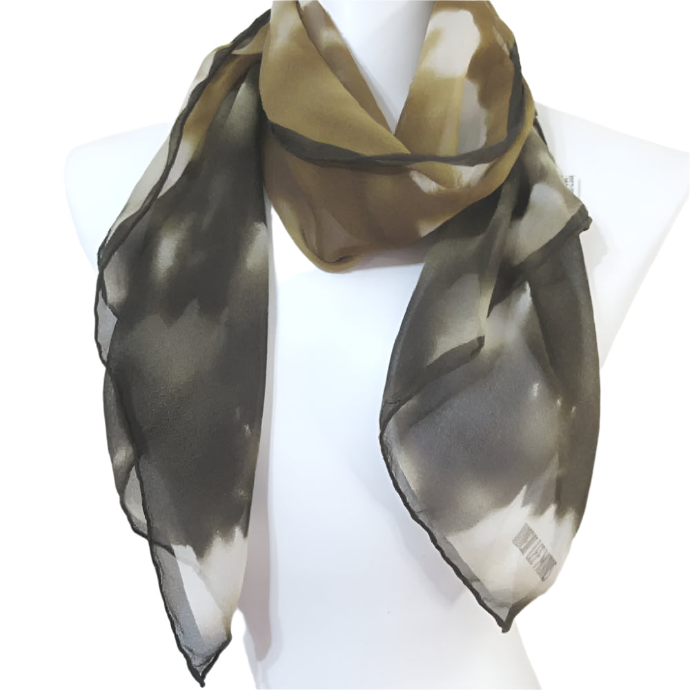 Robert Lee Morris silk scarf with a gradient pattern draped over a mannequin on a white backgrounds