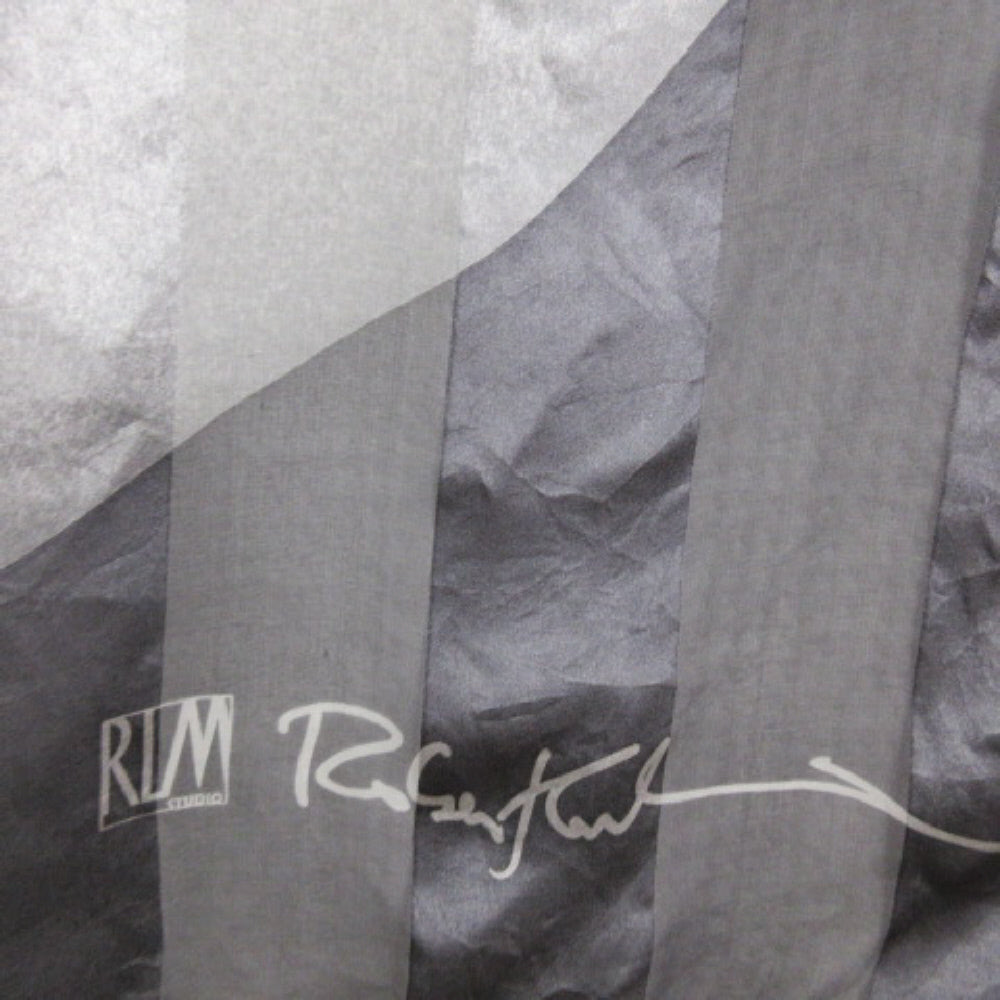 Gray fabric with 'RLM' branding and signature on a textured background