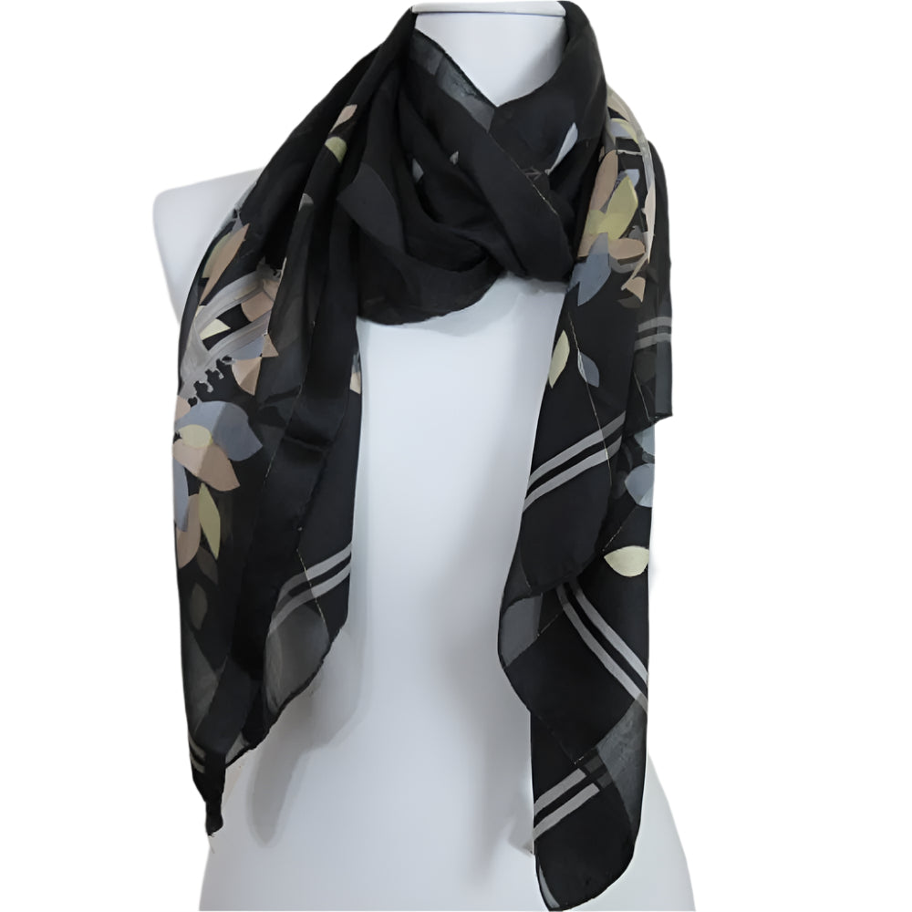 Black scarf with floral pattern on a mannequin against a plain background