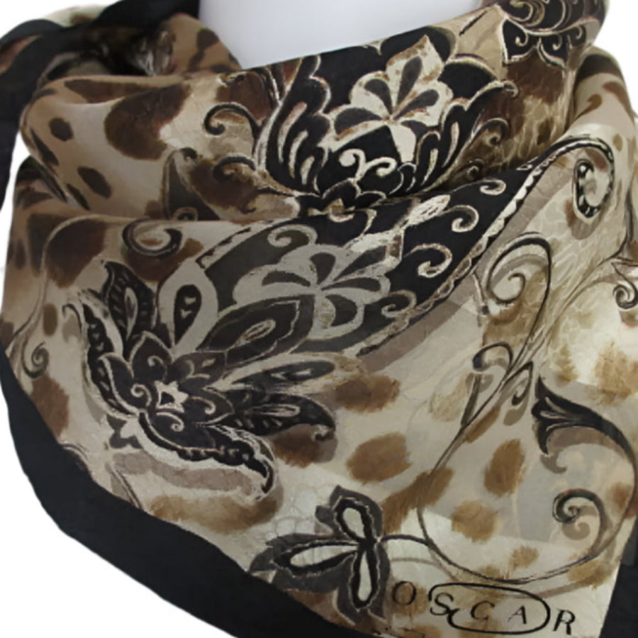 Decorative scarf with intricate patterns and 'Oscar' branding on a white background