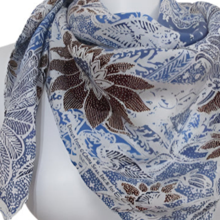Scarf with floral pattern on a mannequin against a white background