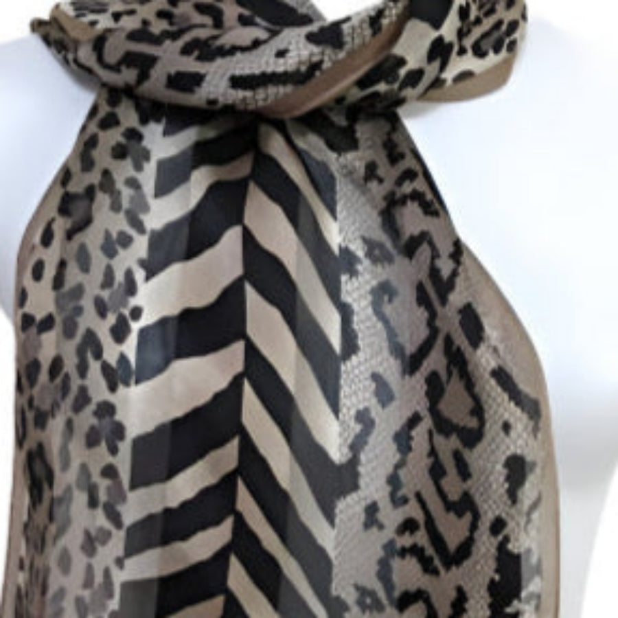 Adrienne Vittadini Mannequin wearing a scarf with chevron and leopard print patterns, brand 'Adrienne' visible.