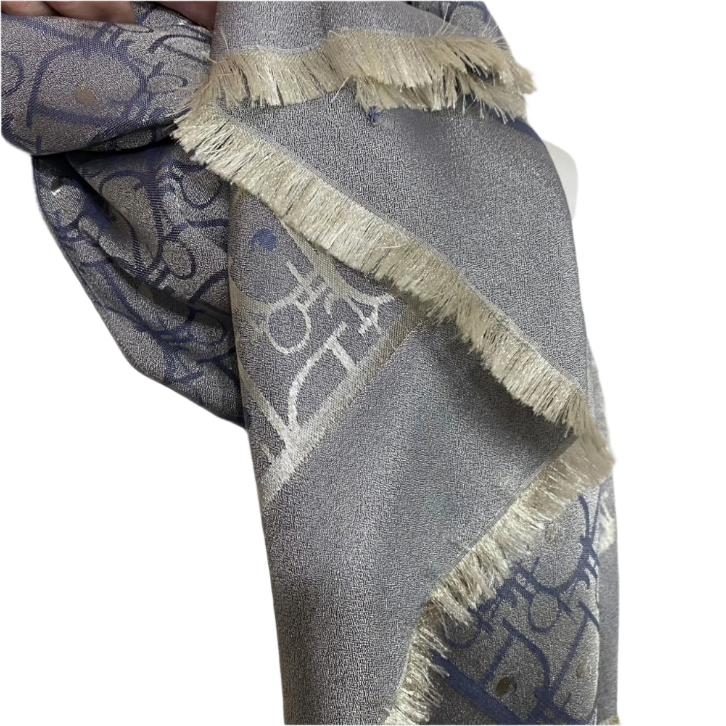 Christian DiorGray scarf with decorative patterns and fringes on a mannequin.