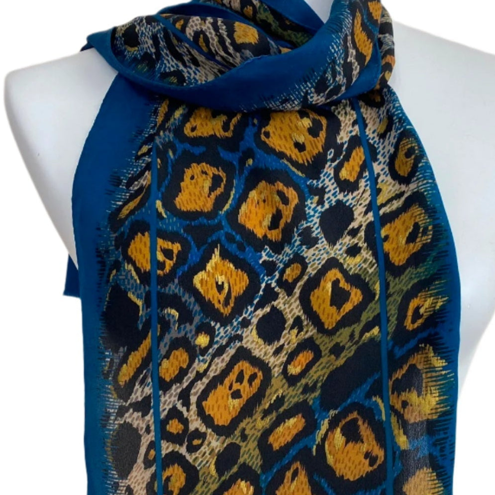 Adrienne Vittadini Blue scarf with a pattern on a mannequin against a beige background