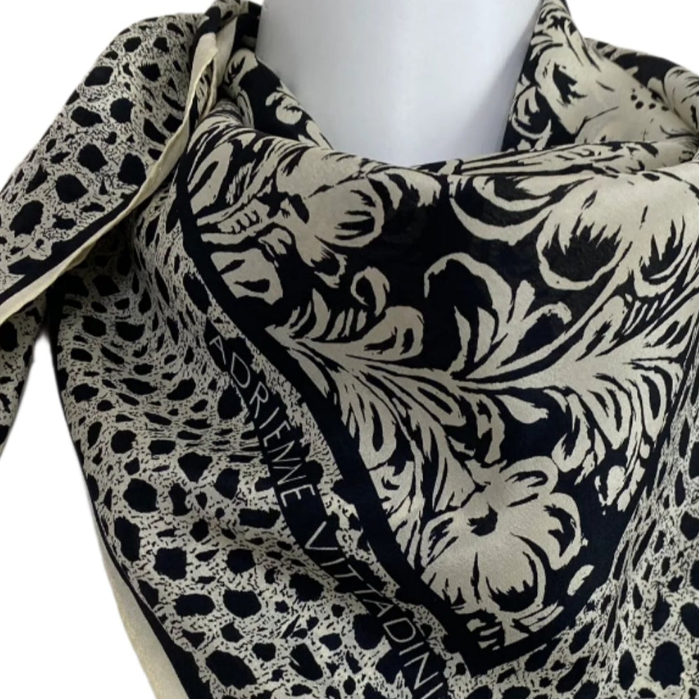 Black and white patterned scarf on a mannequin with a plain background