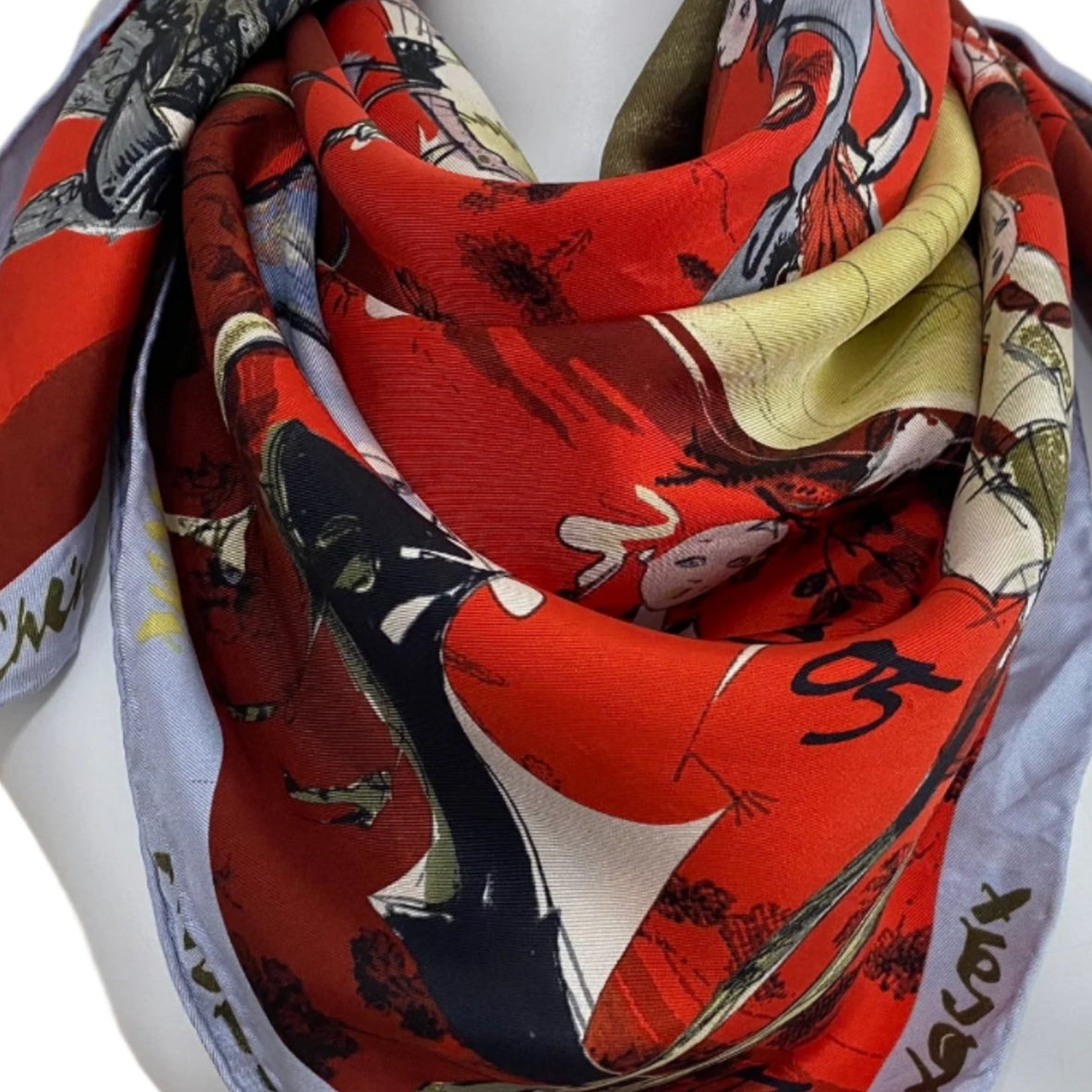 Colorful Christian Lacroix silk scarf with artistic design on a mannequin against a 