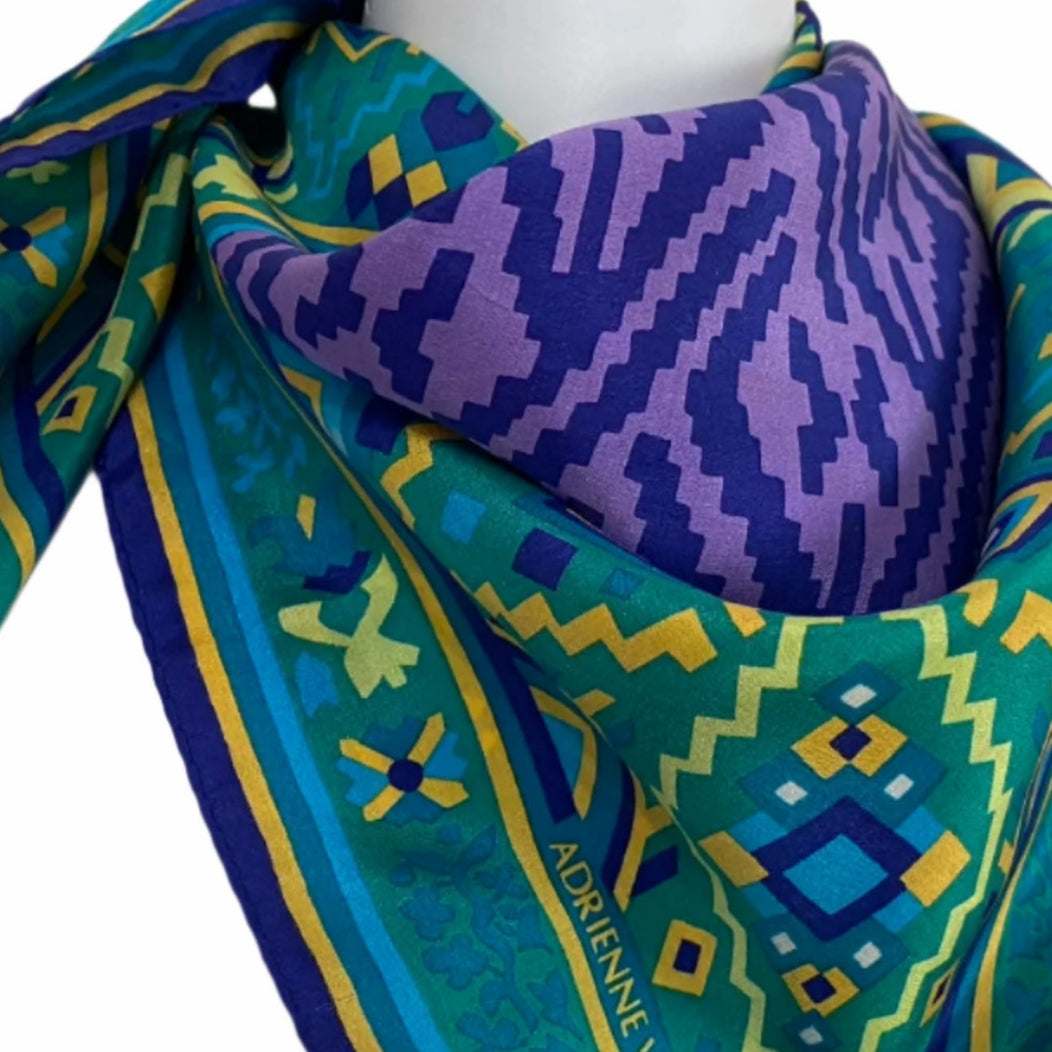 Colorful patterned Adrienne Vittadini scarf on a mannequin with a plain background