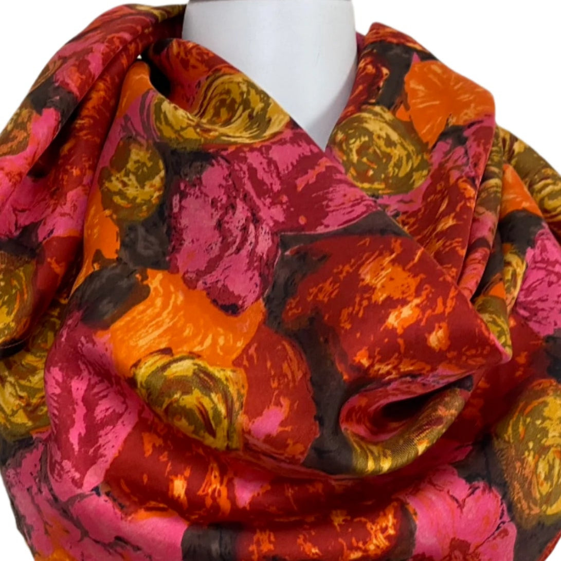 Colorful floral patterned scarf on a mannequin against a plain background