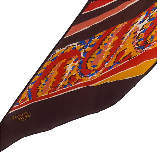 Monique Martin Colorful patterned fabric with a brand logo on a white background