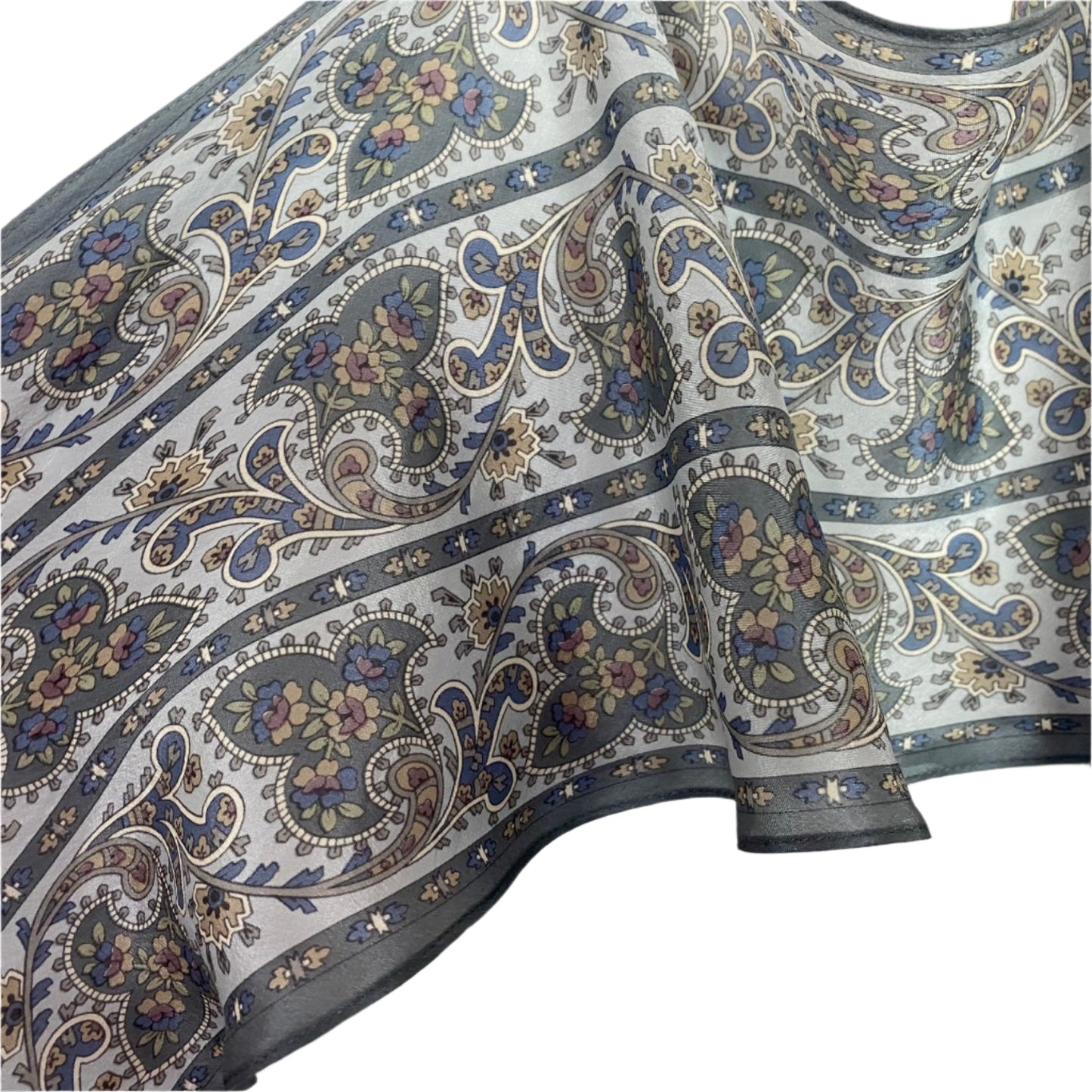 Liz Claiborne Close-up of patterned silk with paisley design on a white background