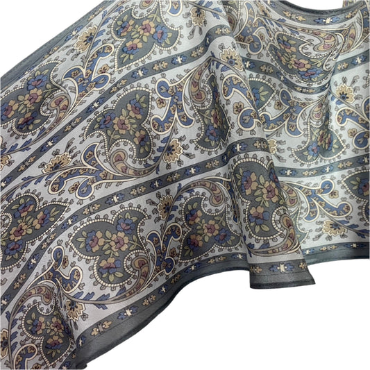 Liz Claiborne Close-up of patterned silk with paisley design on a white background